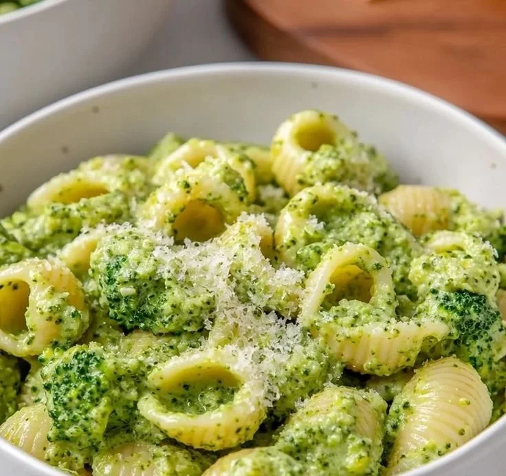 A vibrant bowl of easy healthy broccoli pasta topped with cheese and herbs.